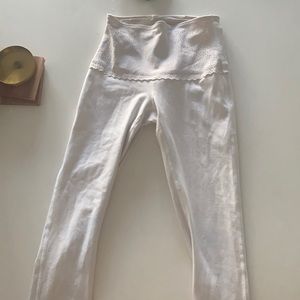 First edition Lululemon white leggings. Size 4. Floral waist band.